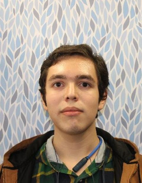 A portrait of yours truly, taken against a geometric backdrop